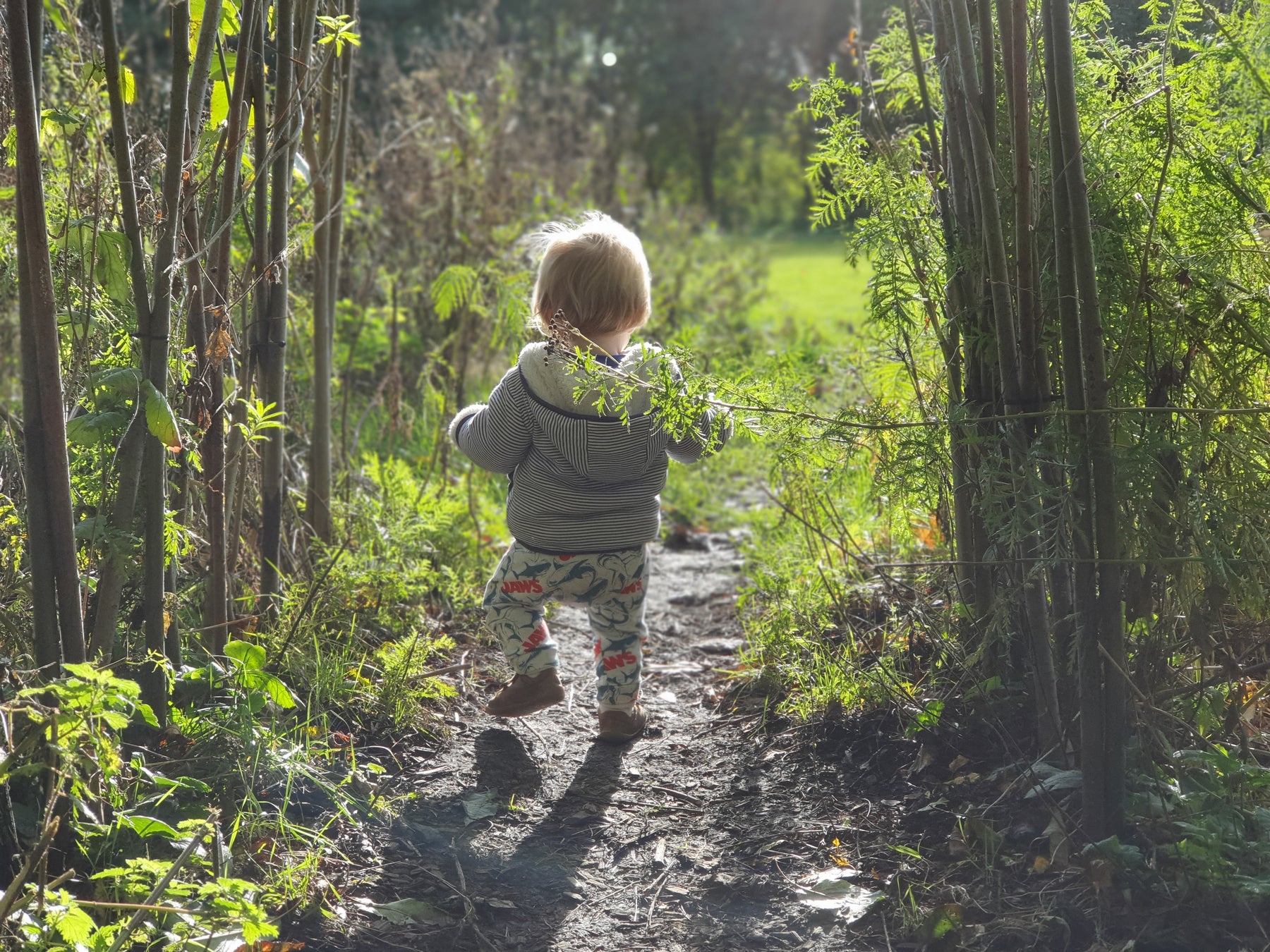 Child exploring nature wearing awesome second-hand clothes